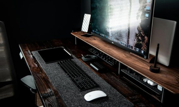 a monitor keyboard and a mouse on a table 570x342 - Is Vinyl To Digital Conversion Worth It? Find Out