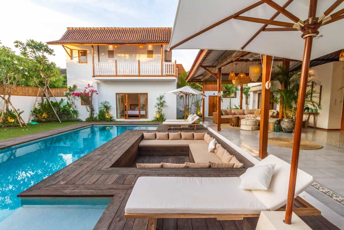 couch and sunbeds near the pool - How to Transform an Outdated Pool Into a Modern Oasis