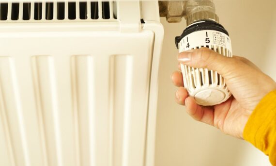Hand of a Person Turning the Radiator Valve 570x342 - How to Spot Warning Signs Your Heater Needs Repair