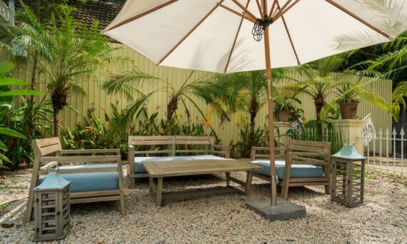 garden patio with wooden chairs table and umbrella 570x342 - How the 2026 Water Supply Picture Is Reshaping Tropical Yards Across San Diego County