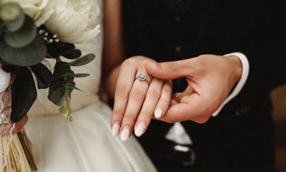 A close up of a couples hands with wedding ring 570x342 - Singapore's Marriage Numbers Just Hit a Decade Low. What That Means for Small Weddings